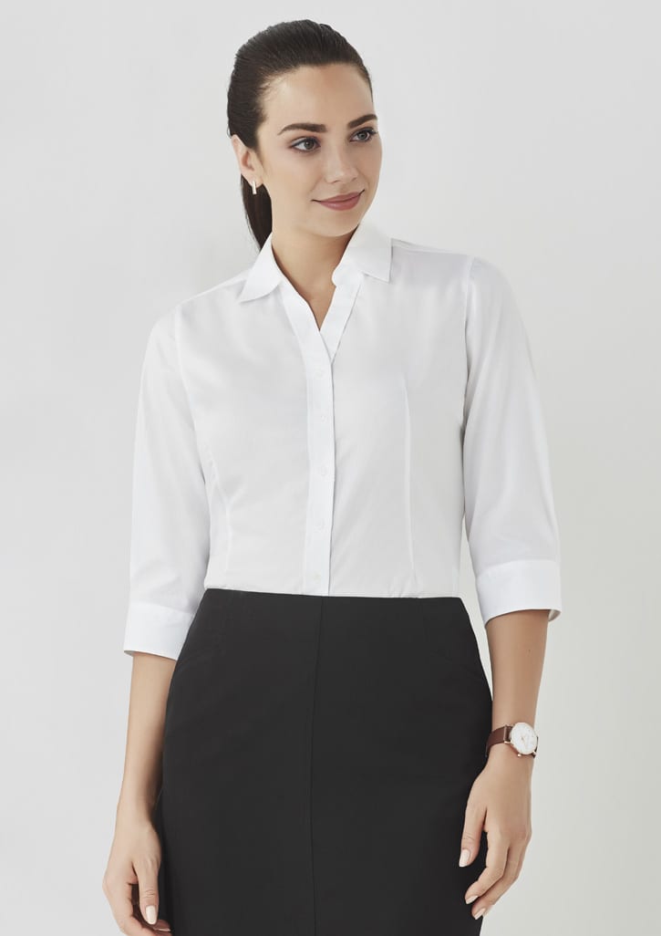 A white women's button-up shirt with 3/4 sleeves, styled with a collar and featuring a logo.