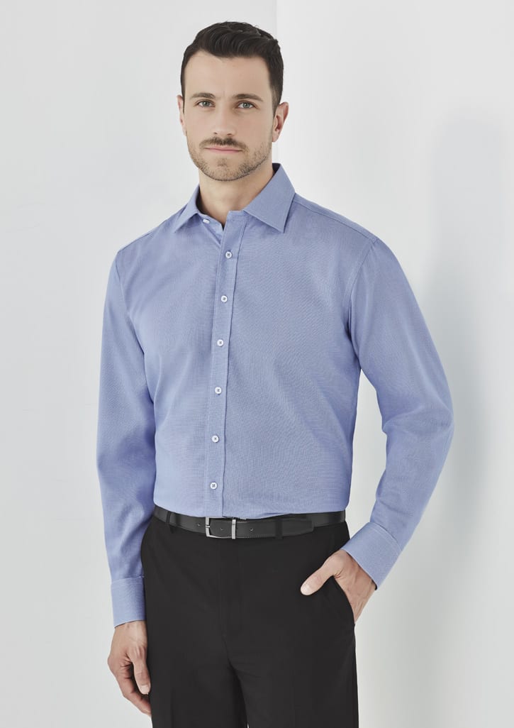 A long-sleeve button-up shirt in light blue, featuring a standard collar and a fitted design, worn with black trousers.