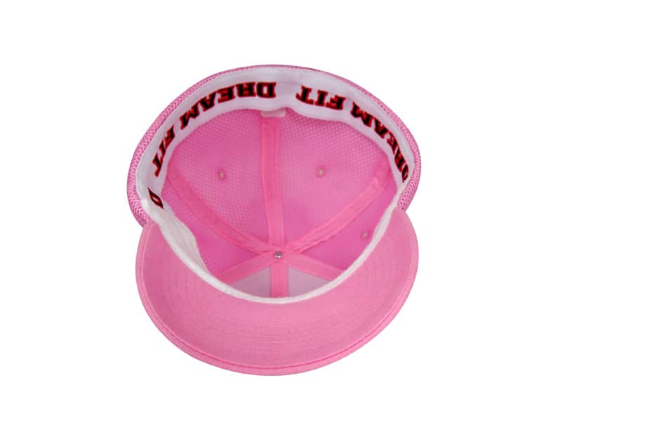 A pink sandwich mesh cap with a structured brim and a mesh interior. It features branding inside the cap.