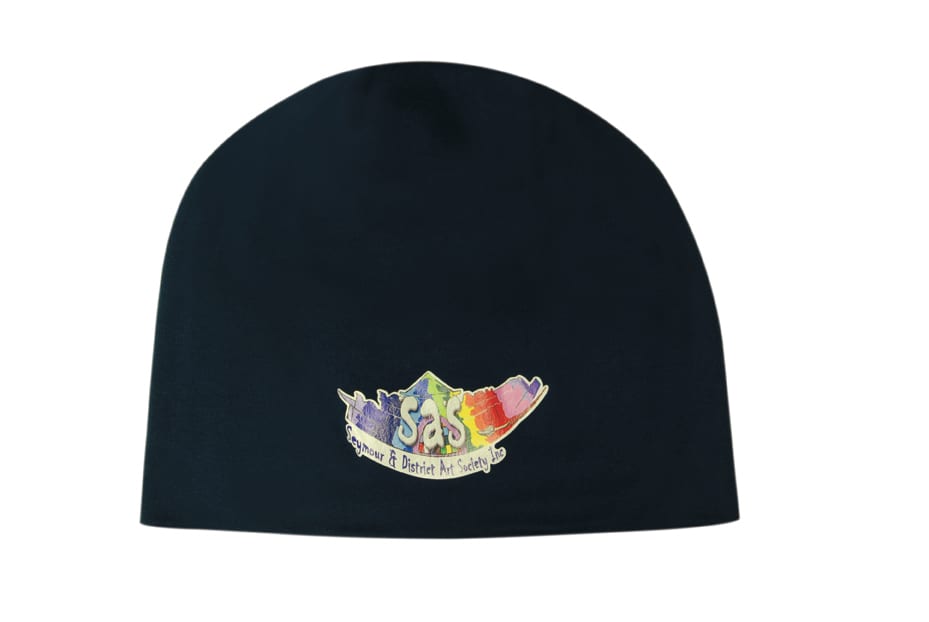 A rolled down cotton beanie in black featuring a logo in vibrant colours.