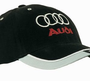 A black brushed heavy cotton cap with reflective trim and tab on the peak, featuring a logo on the front.