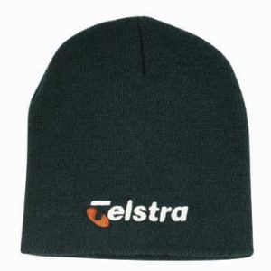 A green rolled down acrylic beanie featuring a logo.