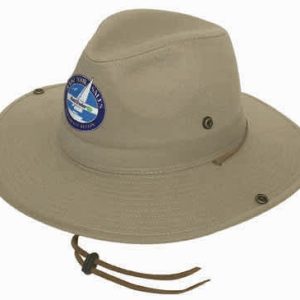 A light beige cotton twill bucket hat with a logo, featuring ventilation eyelets and a chin strap.