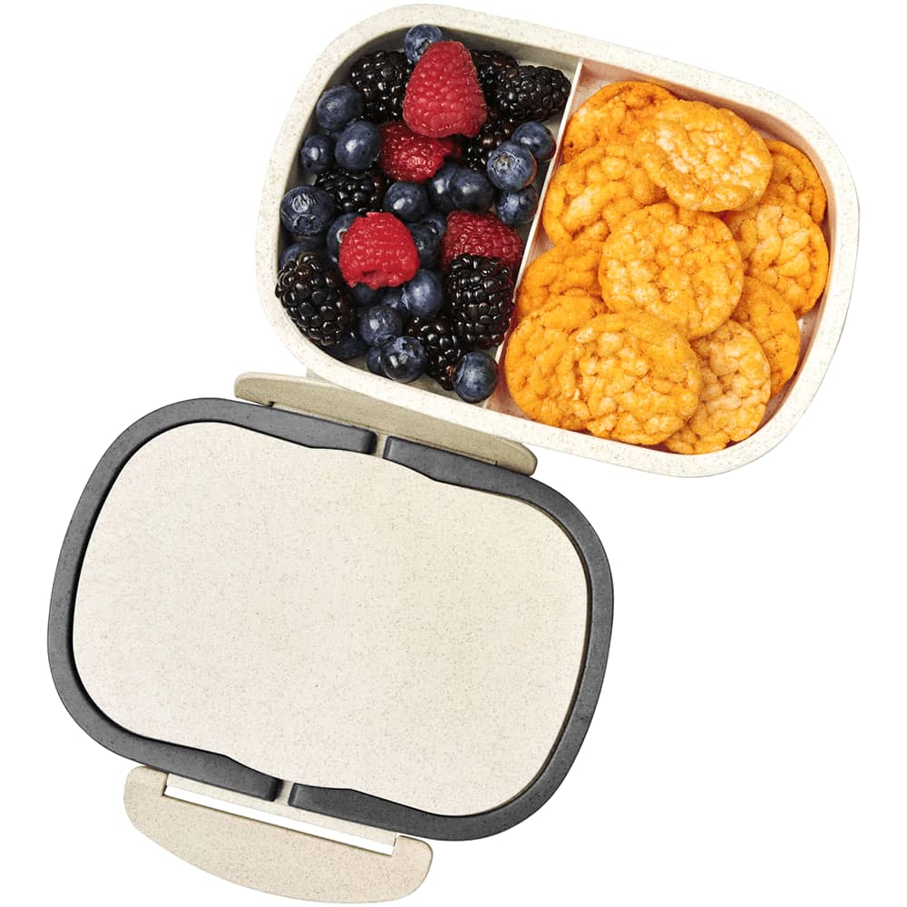 A plastic and wheat straw lunch box in beige, featuring compartments for snacks and fruit. It has a lid and branding.