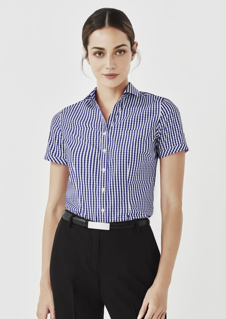 A women's short sleeve button-up shirt featuring a blue and white gingham pattern. The shirt has a collar and a logo.