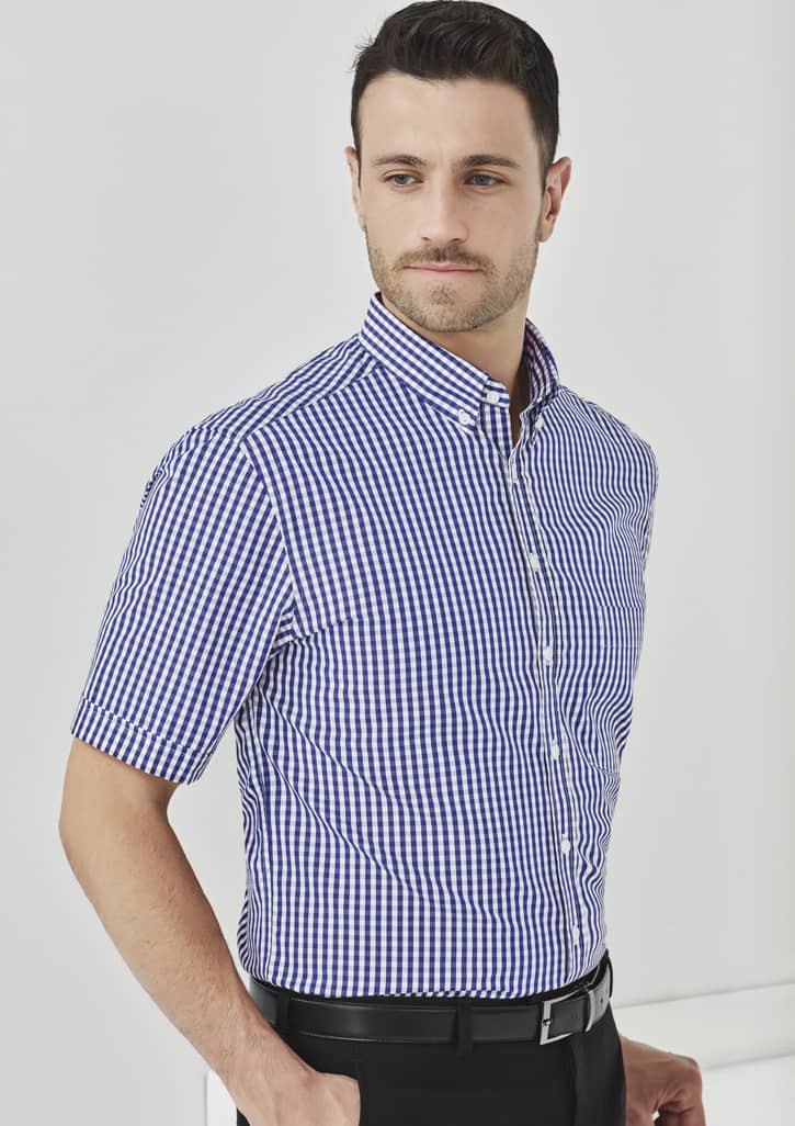 A short-sleeve button-up shirt in a blue and white checkered pattern, featuring a collar and a branded logo.