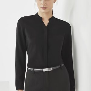 A black long sleeve blouse with a collar, paired with tailored pants, featuring a belt and a logo.