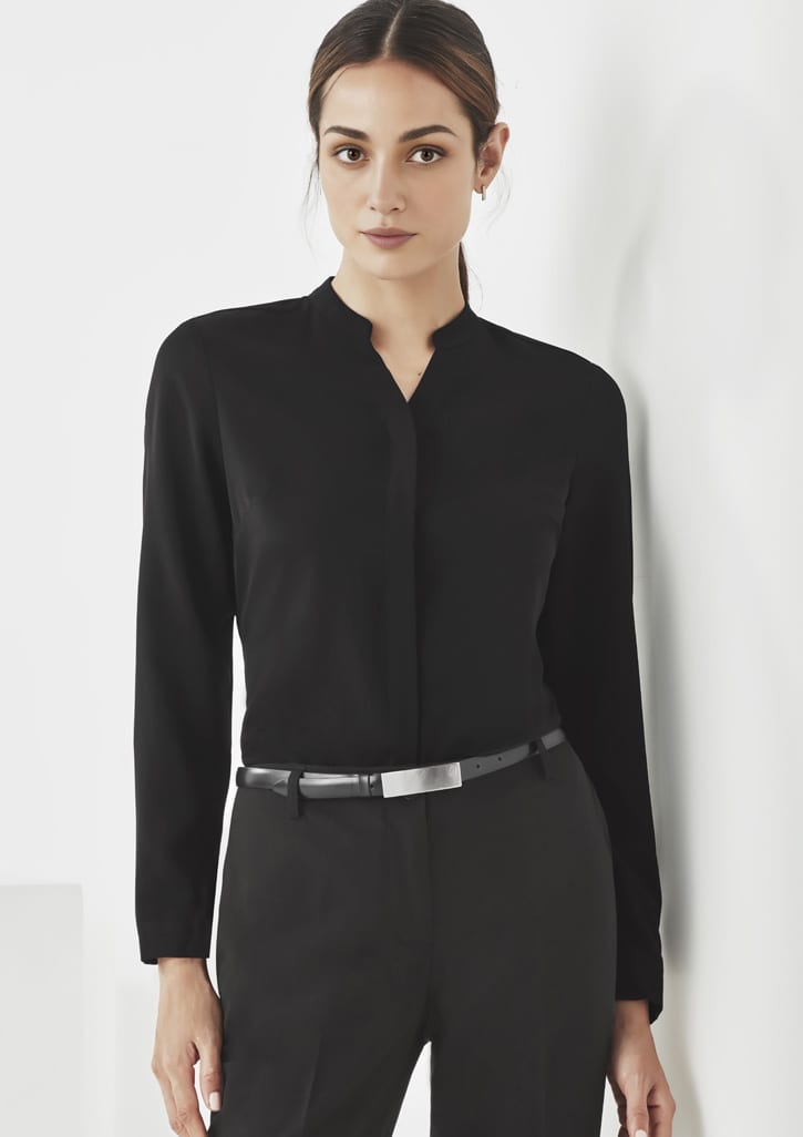 A black long sleeve blouse with a collar, paired with tailored pants, featuring a belt and a logo.
