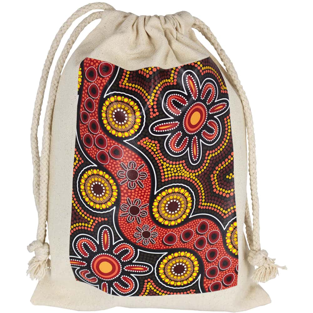 A cream-coloured drawstring bag featuring Indigenous artwork in vibrant reds, yellows, and blacks. It has a logo.