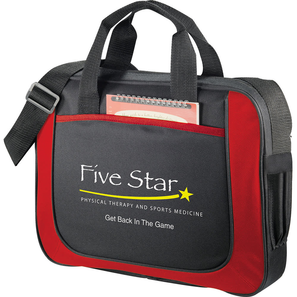 A red and black laptop briefcase with handles, a shoulder strap, and a front pocket holding a notepad.