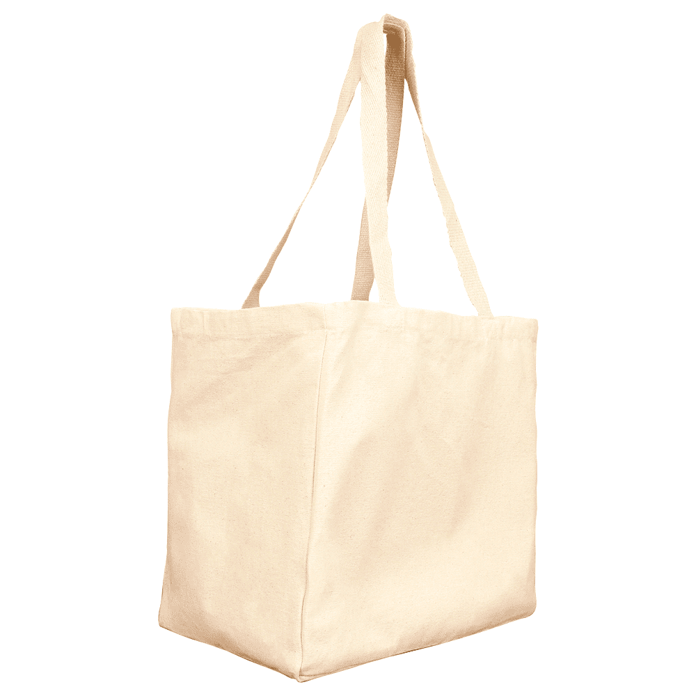 A cream-coloured reusable grocery tote bag with long handles, placed on a sofa. The setting includes natural decor elements.