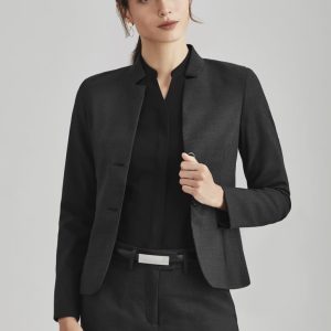 A women's black comfort wool stretch short jacket with reverse lapel, styled with a black top and belted trousers.
