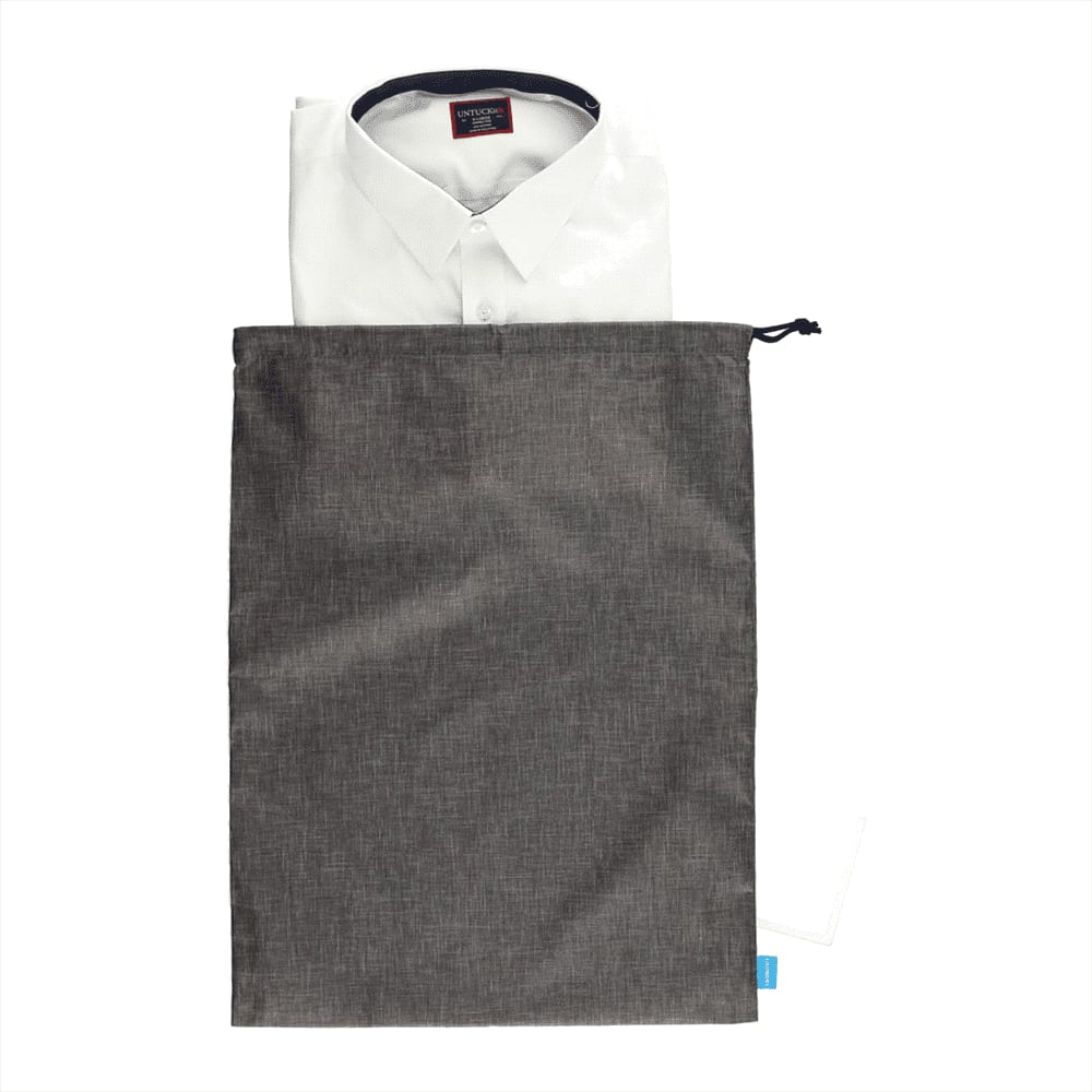 A grey toiletry bag containing a neatly folded white shirt. The bag features a drawstring closure and a logo.