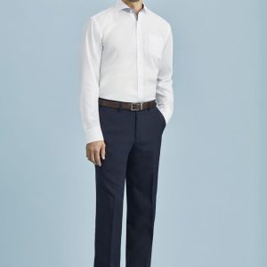 A man wearing a white shirt and navy blue flat front pants, standing against a light blue background.