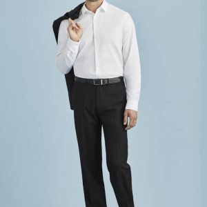 A man wearing a white shirt and black adjustable waist pants, holding a jacket over his shoulder against a light blue background.