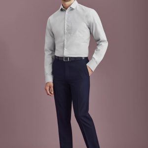 Men's slim fit flat front pants in navy, paired with a light grey shirt and black shoes. Features a logo on the waistband.