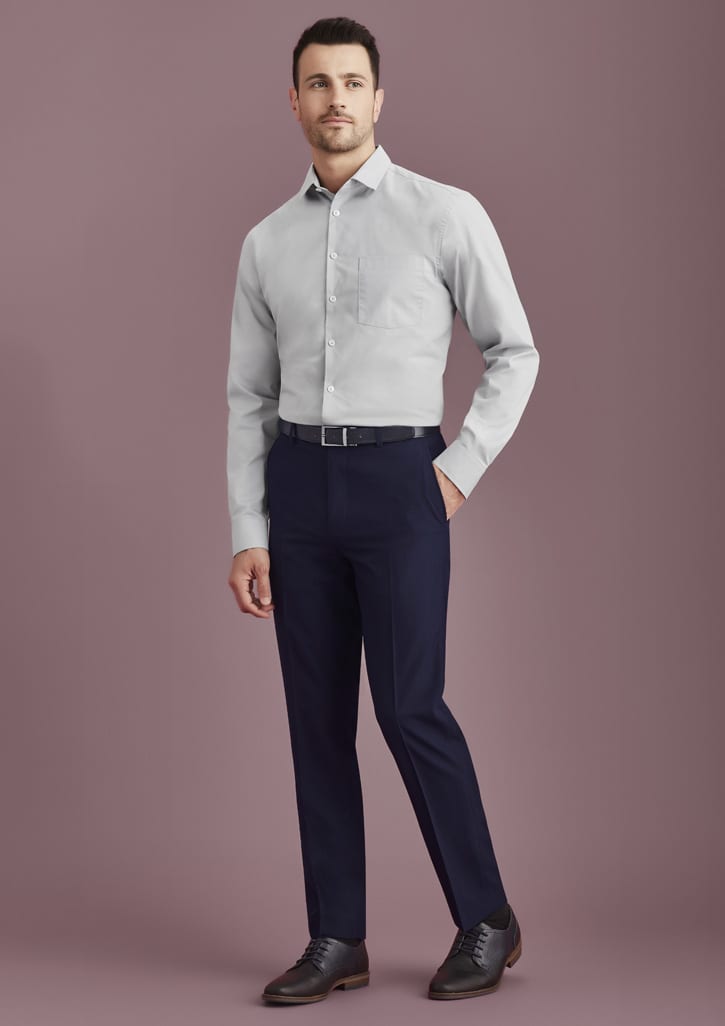A man wearing a light grey shirt and navy blue slim fit flat front pants, complemented by black shoes and a belt.
