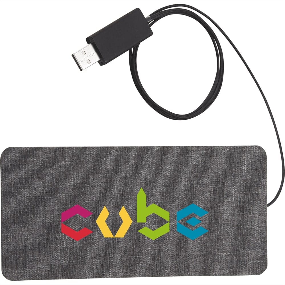 A grey fabric wireless charging pad with a USB connection and a multicoloured logo.