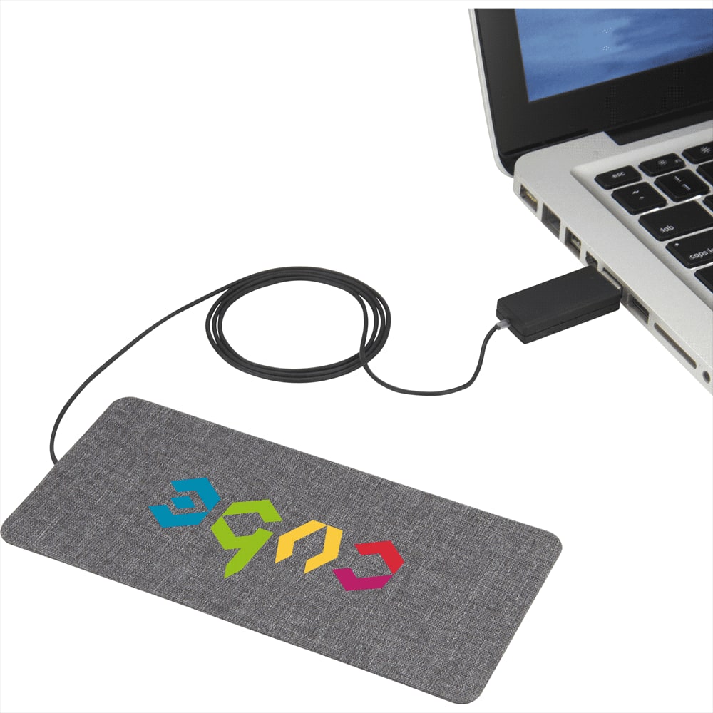A wireless charging pad in grey fabric, connected to a laptop with a black cable, featuring a colourful logo.