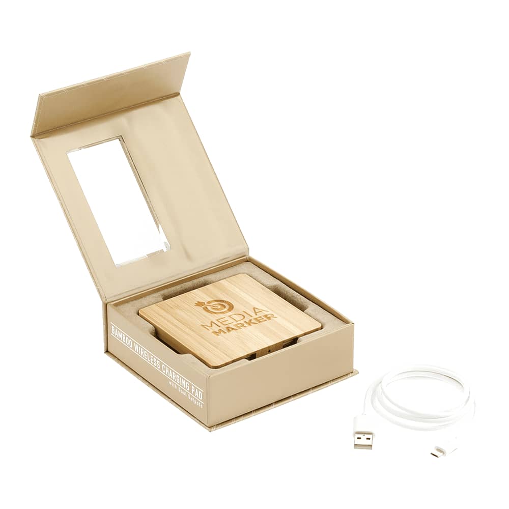 A bamboo wireless charging pad with dual outputs, presented in a box, alongside a USB charging cable.