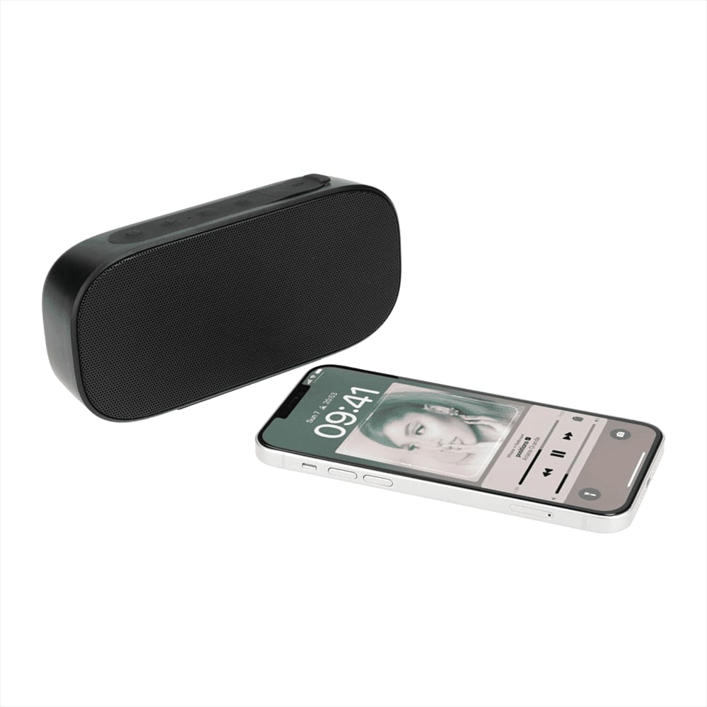 A black Bluetooth speaker next to a smartphone displaying music playback, featuring a logo on the speaker.