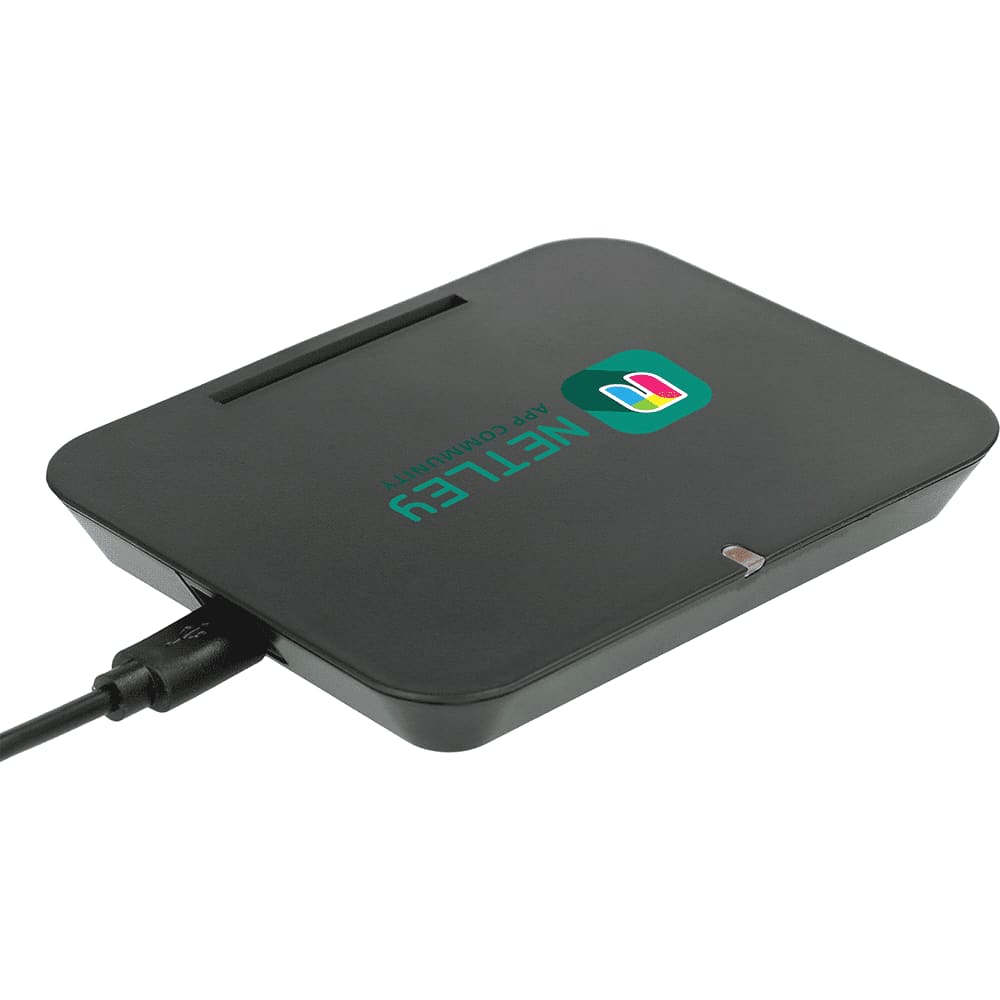 A black wireless charging phone stand with a logo and a charging cable connected.