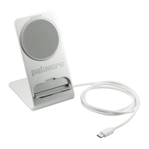 A silver wireless charging stand with a circular charging pad and a white USB-C cable. It features a logo on the base.