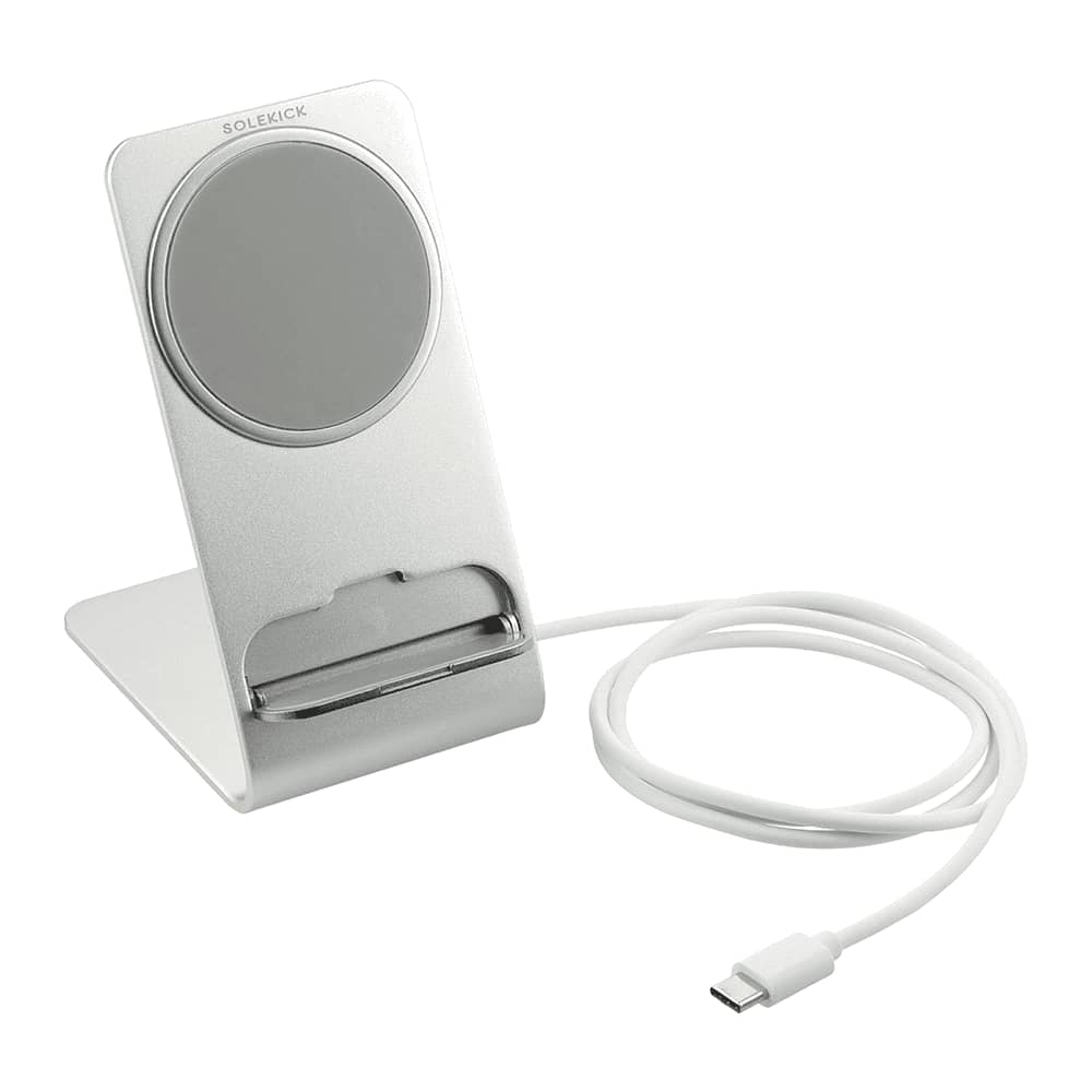 A silver wireless charging stand with a sleek design and a connected white charging cable. It features a logo on the front.