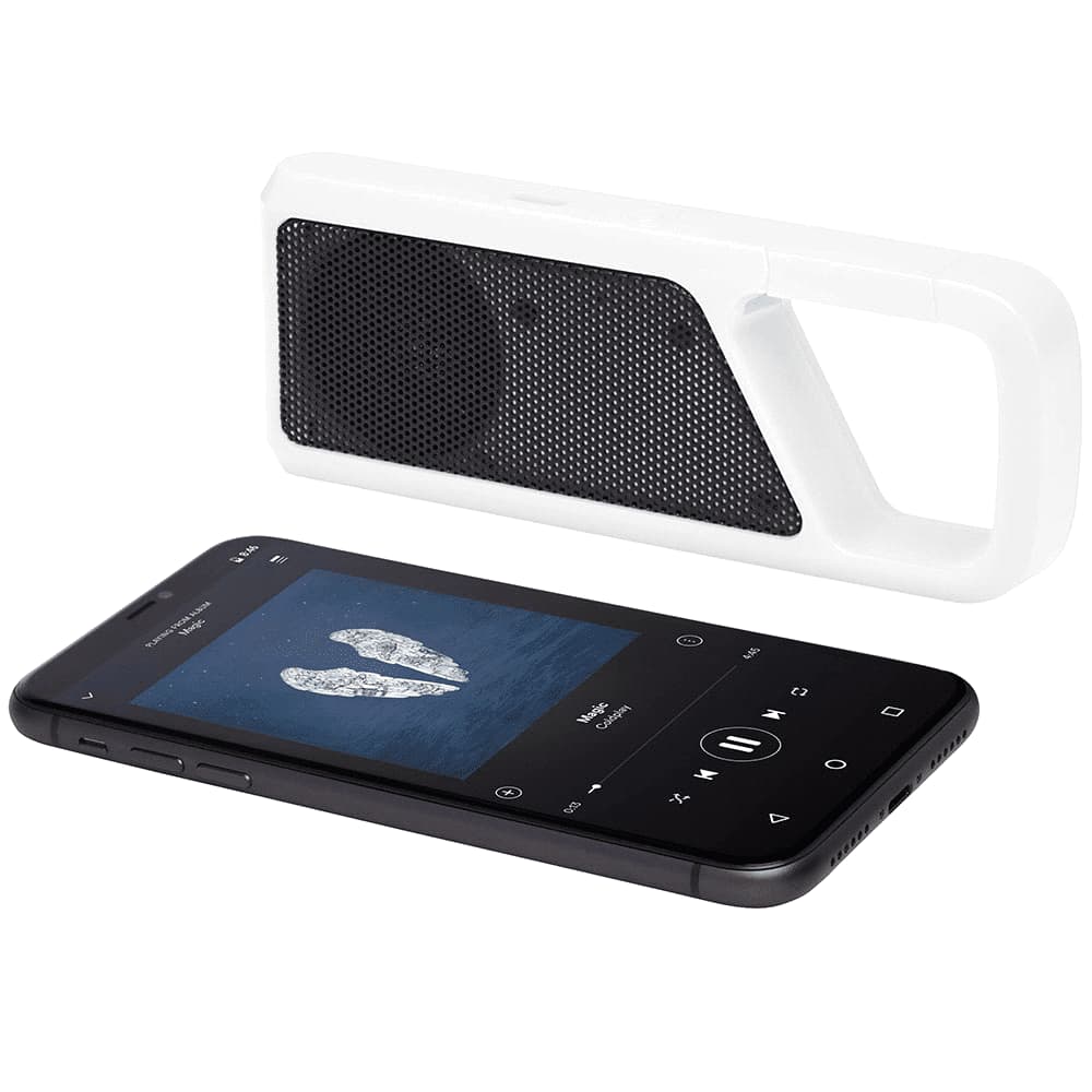 A white Bluetooth speaker with a handle next to a black smartphone displaying music playback. The speaker features a mesh grill.
