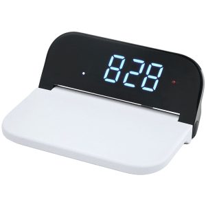 A digital clock with a black display and white base, featuring a wireless charging area.