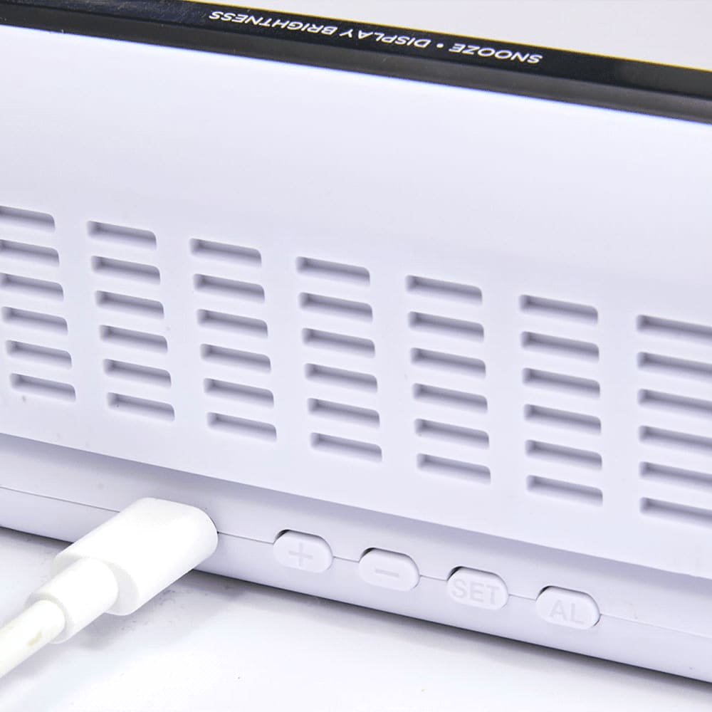 A white digital power clock with buttons and a charging port, featuring a sleek design and a logo.