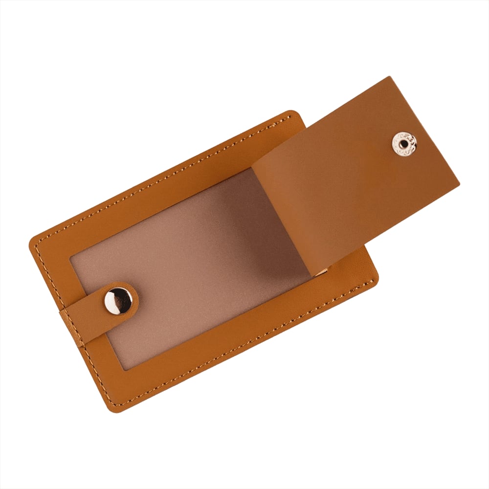 A tan-coloured bio leather luggage tag with a snap closure and an open fold revealing a blank interior.
