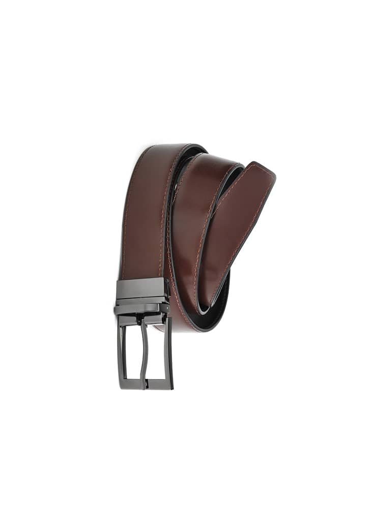 A brown leather reversible belt featuring a sleek silver buckle and contrasting stitching. It has a branded logo.