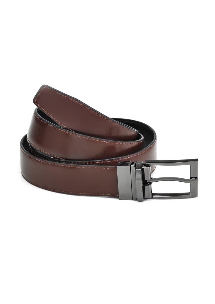 A brown leather reversible belt with a black underside and a silver buckle, featuring a logo.