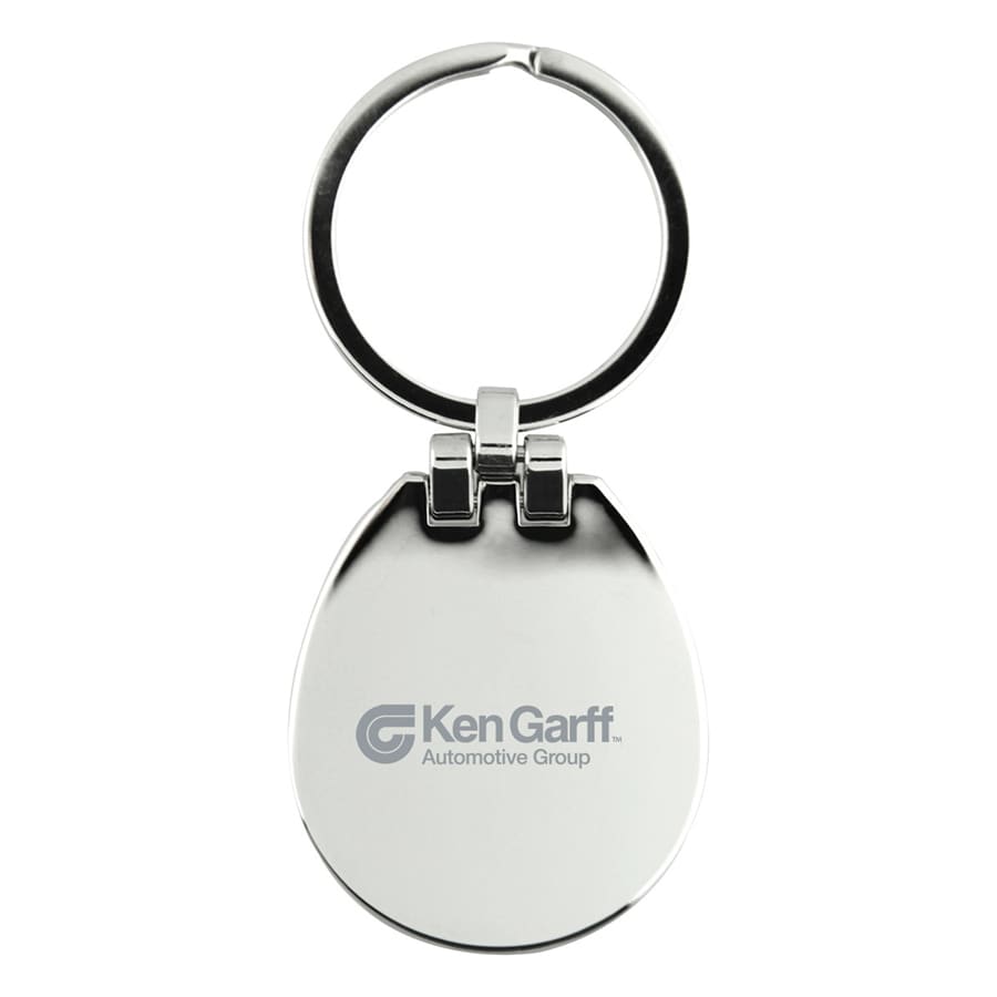A silver keychain with a circular ring and an egg-shaped body, featuring a logo on one side.