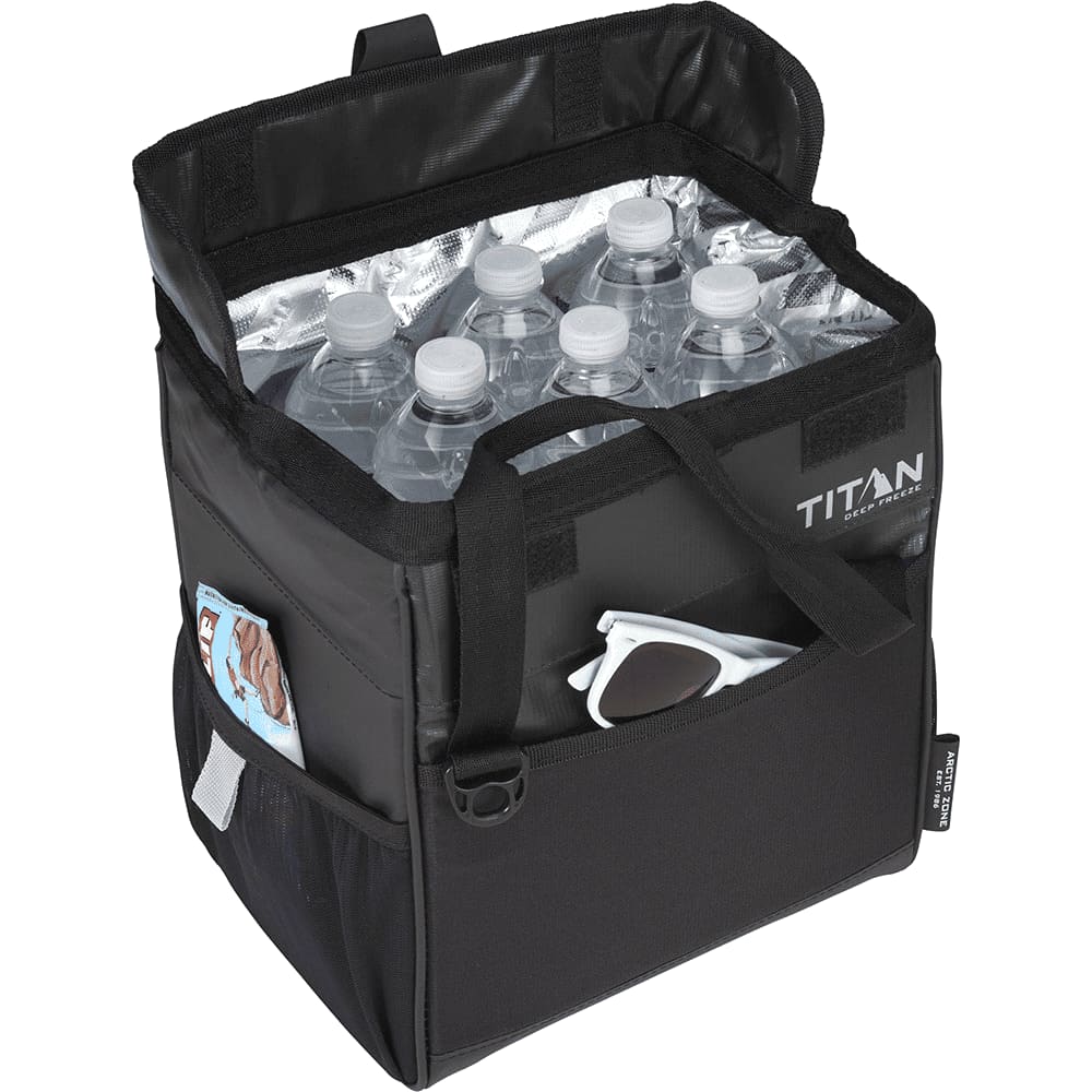 A black lunch cooler bag with a logo, beside a hand holding a blue drink bottle, set on wooden pallets.
