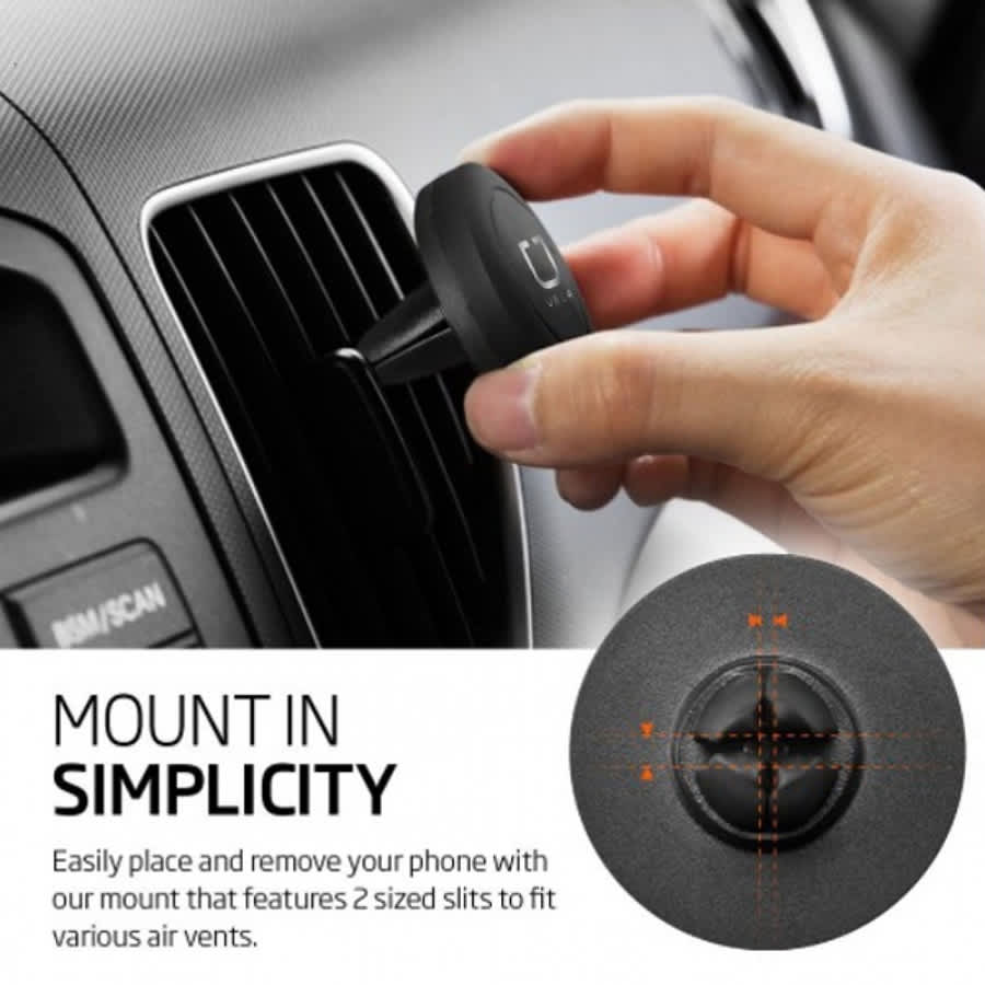 A black universal magnetic car mount being held near an air vent. It features two sized slits for various air vents.
