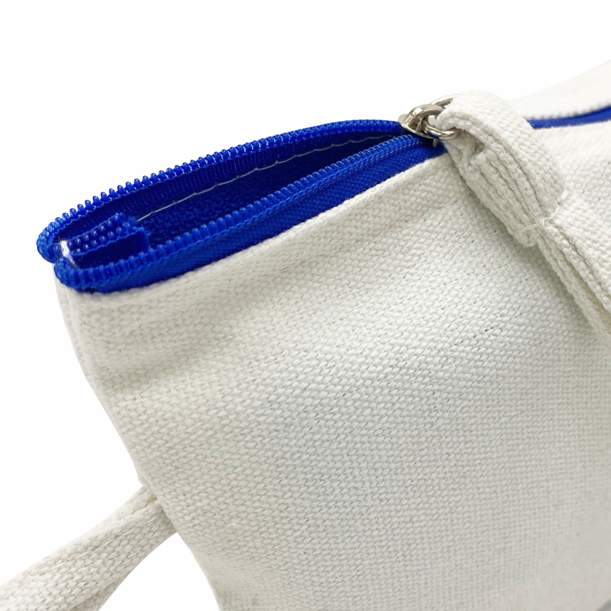 A cosmetic bag in cream with a blue zipper. It features a sturdy fabric and a small handle for easy carrying.
