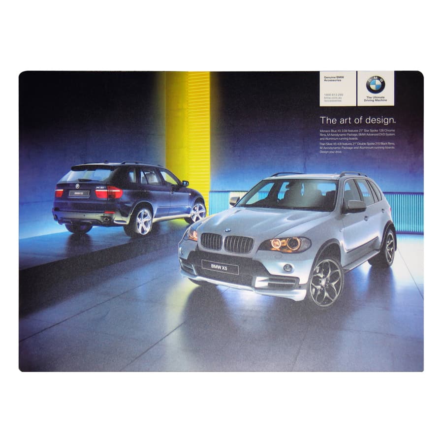 A counter mat featuring two BMW vehicles in a gradient backdrop, highlighting a modern design with vibrant blue and yellow colours.
