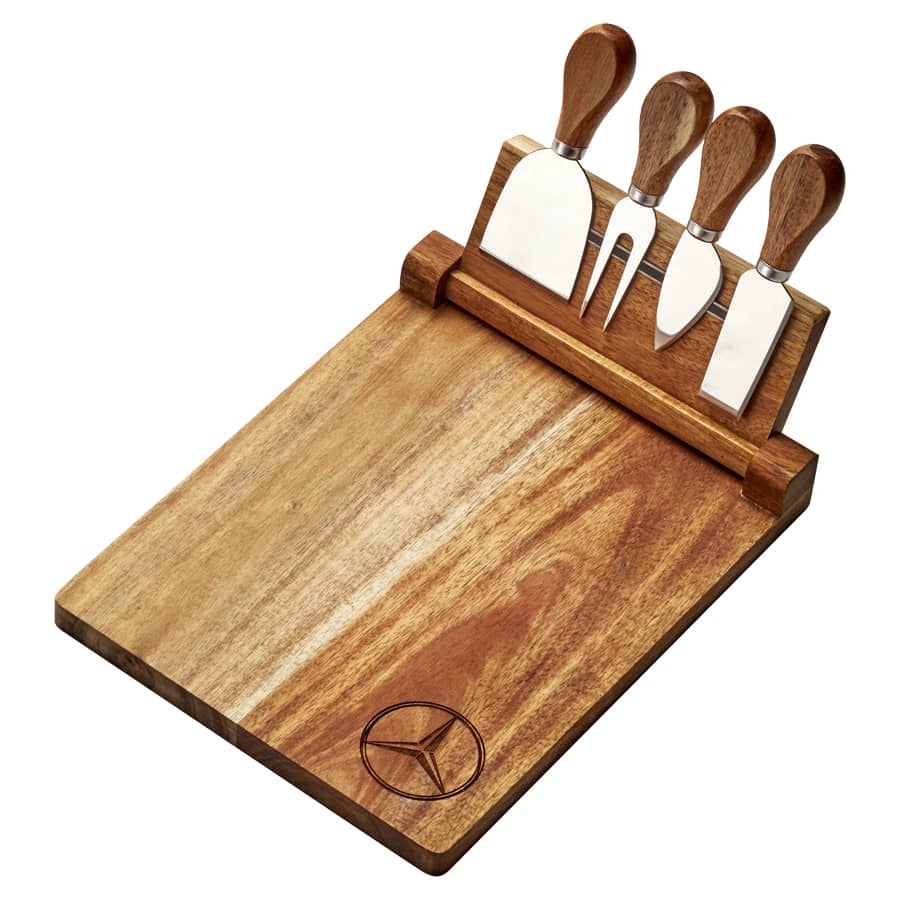 A wooden cheeseboard set featuring four stainless steel knives with wooden handles and a logo.