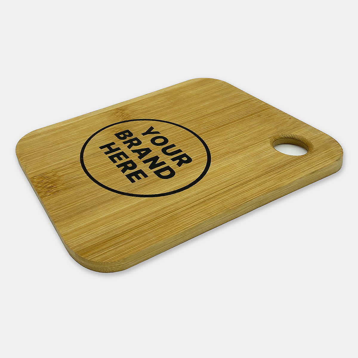 A small bamboo cutting board featuring a round cutout and a printed logo in black.