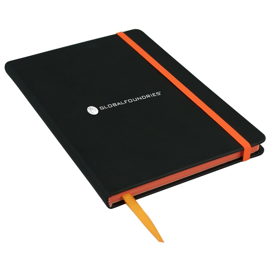 A black A5 journal with an orange elastic band and bookmark, featuring a logo on the cover.