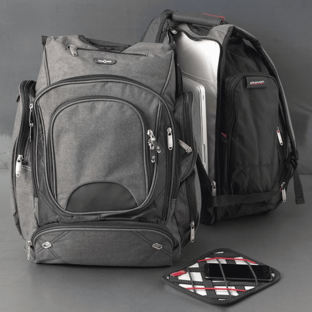 A grey, checkpoint-friendly backpack with multiple compartments and a logo, designed for carrying laptops and equipment.