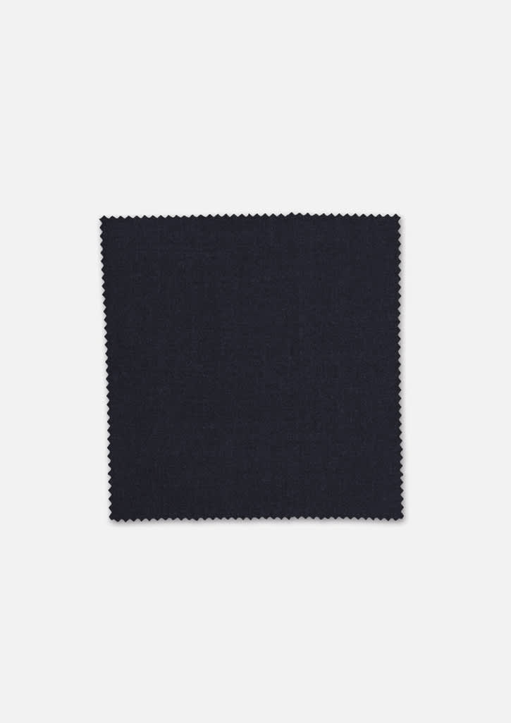 A square swatch of dark navy wool stretch suiting fabric with a textured finish and scalloped edges.