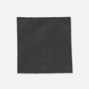 A swatch of dark grey fabric with a textured finish, featuring a zigzag edge. It has a branding logo.