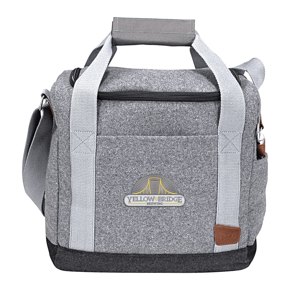 A grey cooler bag with handles near a lake, surrounded by mountains and nature.