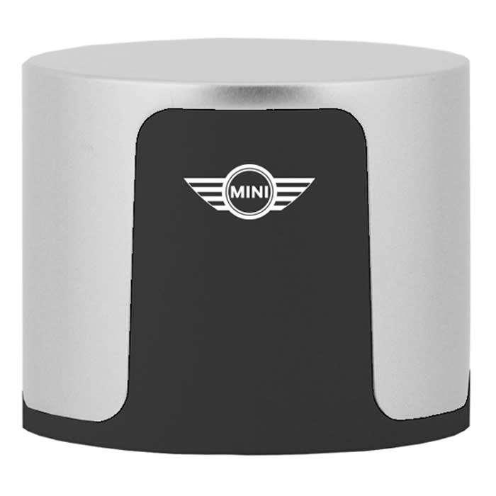 A compact wireless speaker in silver and black with a logo on the front.