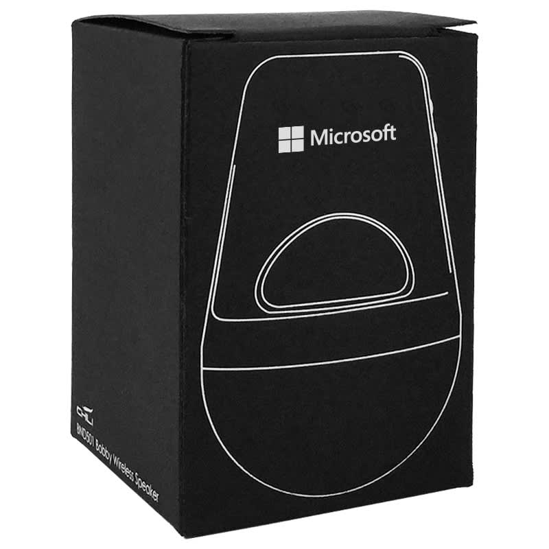 A sleek silver wireless speaker packaged in a black box with a logo. Features a minimalist design.