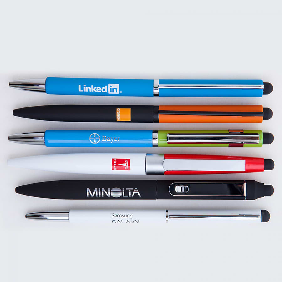 A collection of metal ball pens in various colours including blue, green, orange, black, and white, each with a logo.