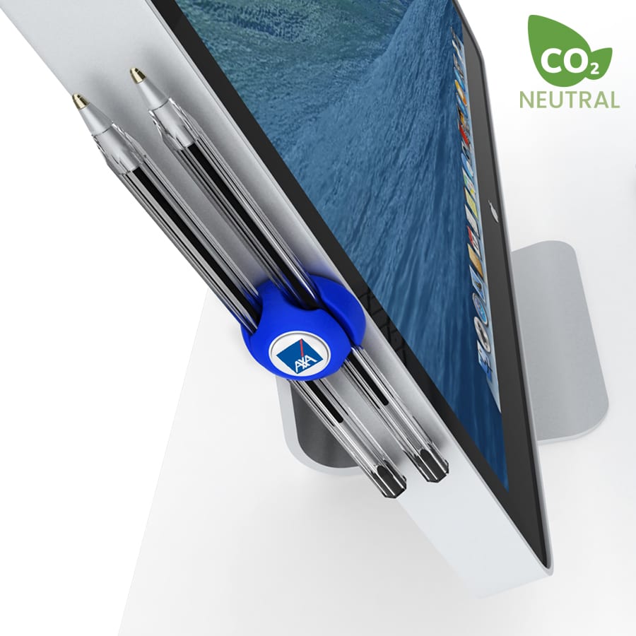 A blue cable manager attaches to a monitor, holding two pens in place. The image features a logo and a neutral badge.